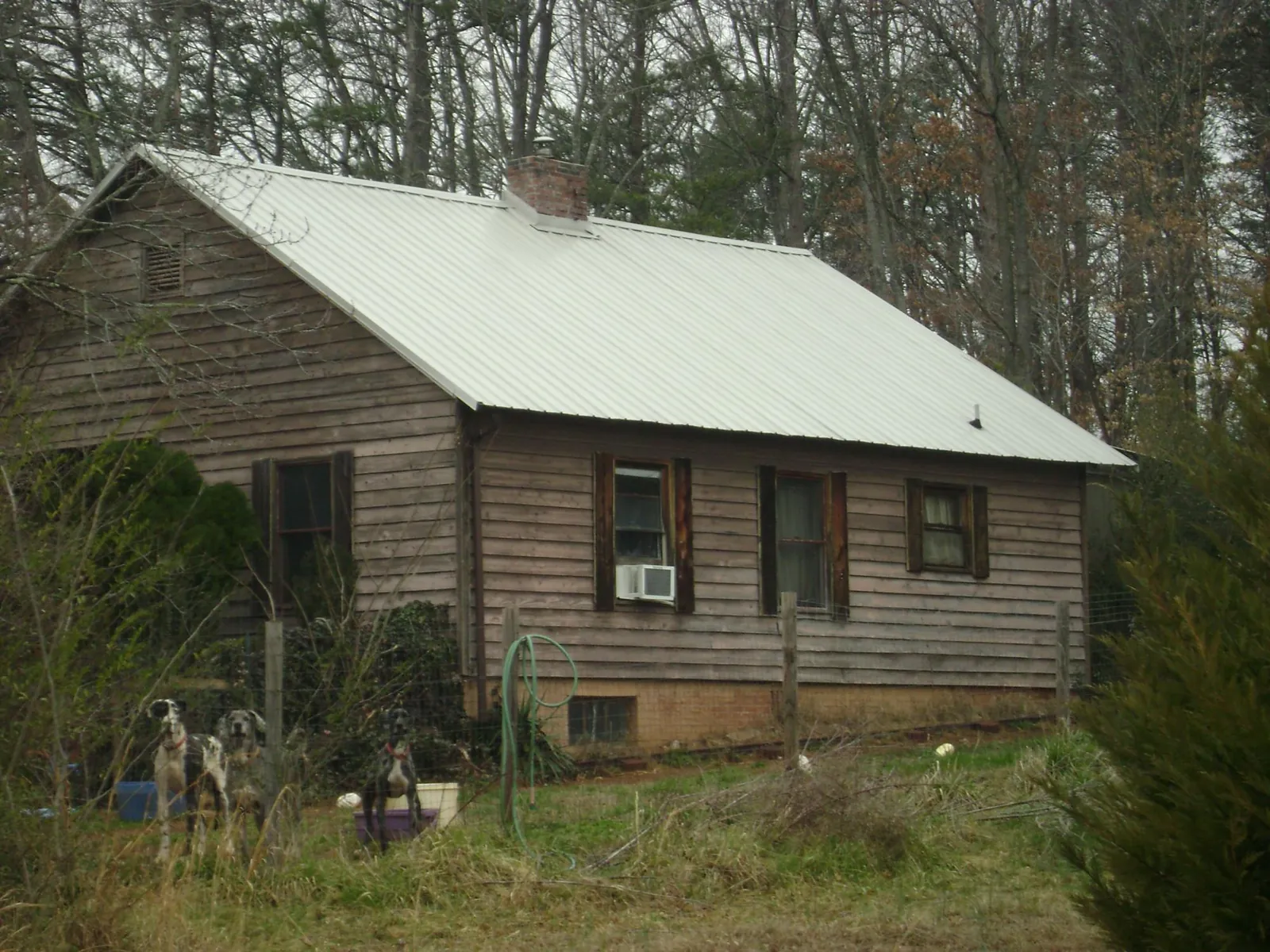 White metal roof on an old wood sided farmhouse, from a Metal Roof Installation job in Mount Holly